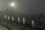 Gondolas docked. Foggy night. Great channel.