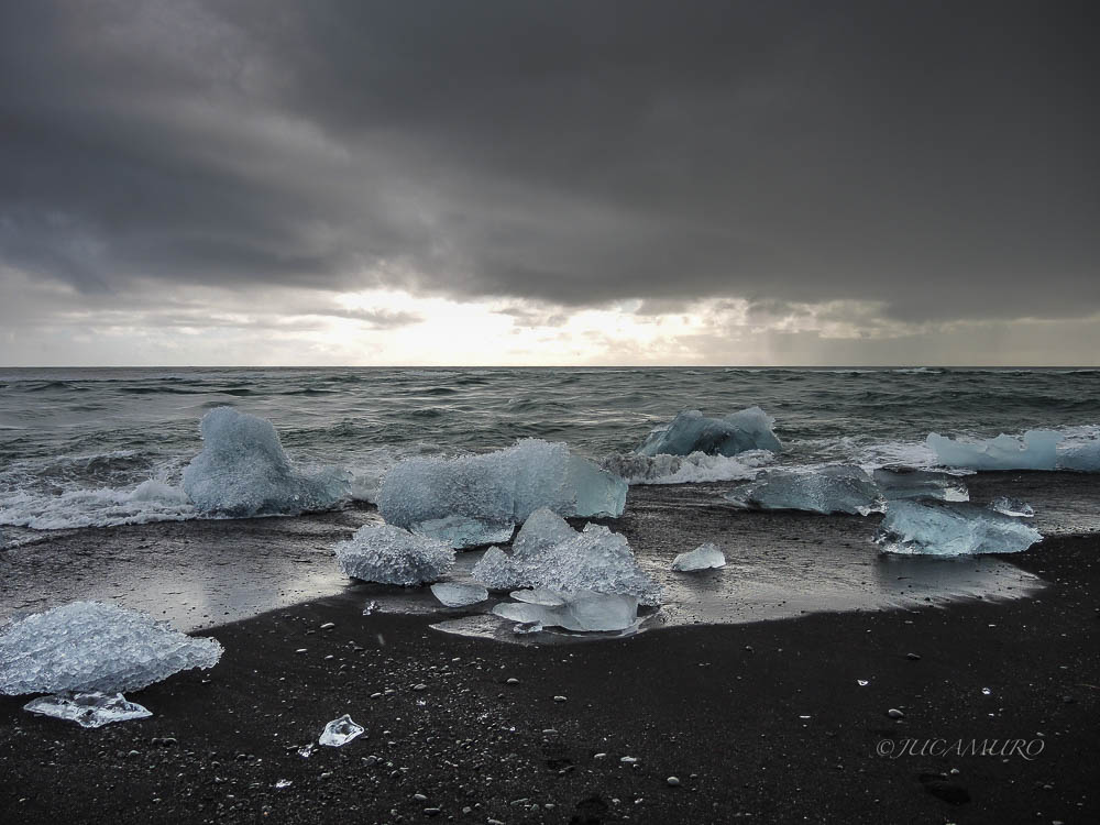 Fragments of glacial ice. Diamond Beach. Ice from the Jökulsárlón glacier lagoon. Iceland.